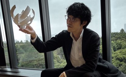 Portrait of Oki Sato of Nendo in front of window, by Caroline Tompkins