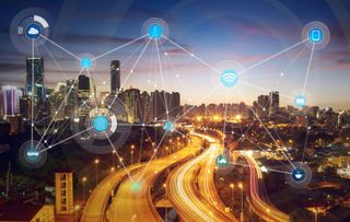 City with web of digital icons denoting a smart city