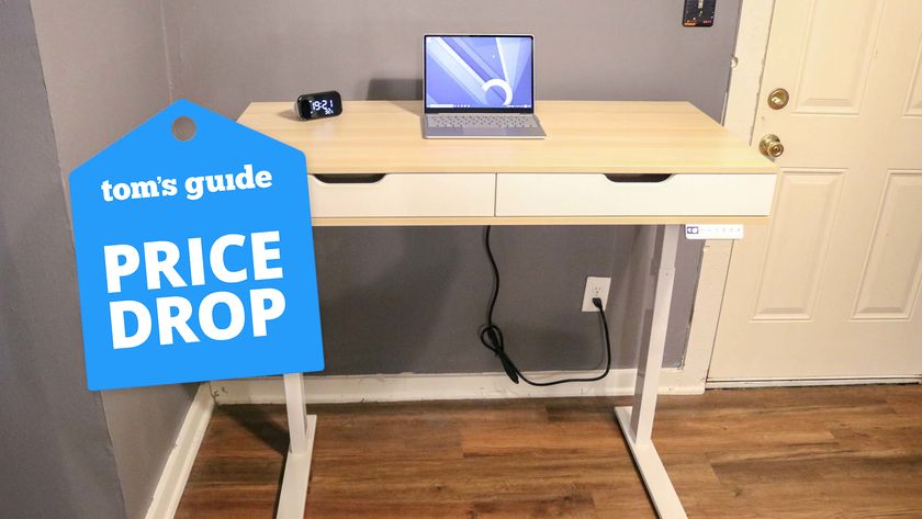 A RealSpace standing desk in a home office with a price drop badge