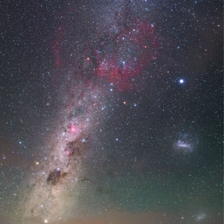 a wispy white cloud of gas in dust seen in deep space