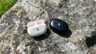 Beats Studio Buds Plus with the Beats Studio Buds original on a rock