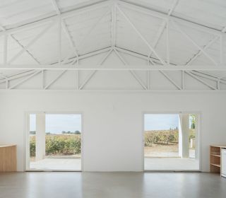 open ceiling structure of pitched roof in all white house