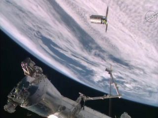 An unmanned Orbital ATK Cygnus spacecraft is seen at the International Space Station on Dec. 9, 2015 just before it is captured by the station's robotic arm. The spacecraft is carrying nearly 4 tons of supplies for the station's crew.