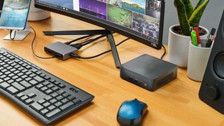 Intel NUC 12 Pro on desk next to monitor