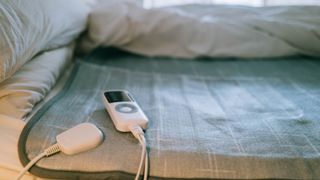 An electric blanket placed on top of a memory foam mattress