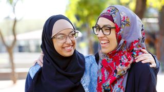 Two Muslim women hugging