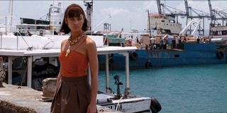 Quantum of Solace Olga Kurylenko standing by the edge of the water