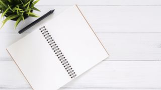 Image of a white journal open on a desk