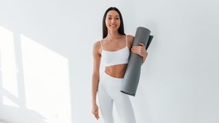 a photo of a woman holding best yoga mats