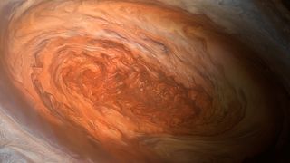 artist&#039;s illustration jupiter great red spot close up showing swirls of rusty red and orange in an oval shape. 