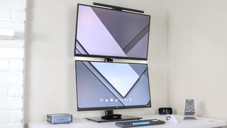 Two 27-inch, 16:9 monitors stacked on top of each other on a desk