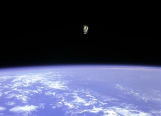Astronaut Bruce McCandless II floats above Earth, 330 feet (100 meters) from the cargo bay of the space shuttle Challenger, in 1984.