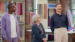 &quot;Great British Sewing Bee&quot; host Kiell Smith-Bynoe shares a joke with judges Esme Young and Patrick Grant in an image from season 10