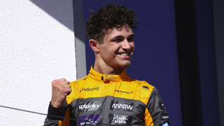 Lando Norris of McLaren celebrates on the podium at the end of the last year&#039;s F1 Grand Prix of Hungary