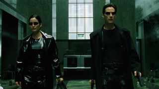 The Matrix screengrab of Trinity and Neo walking along a building