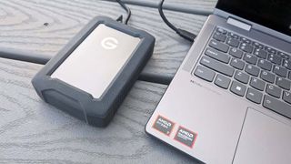 SanDisk Professional G-DRIVE ArmorATD plugged into laptop.