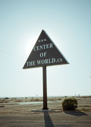 road sign saying Centre of the World