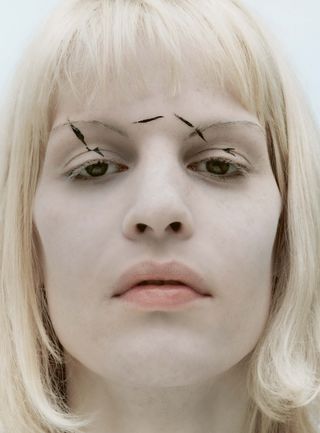 Look from Inge Grognard Makeup book, showing bleached brows and hair with black marks on face