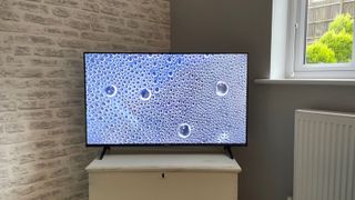 Hisense 43A6KTUK 43-inch TV on a wooden stand. There are bubbles on the screen.