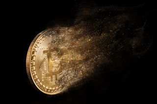 Stock image of a Bitcoin disintegrating