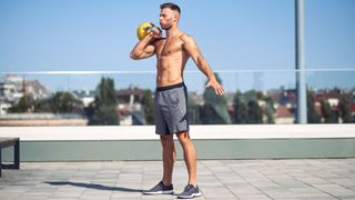 a man performing a kettlebell workout outside