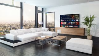 The Panasonic MZ800 OLED TV in a modern flat overlooking a cityscape.