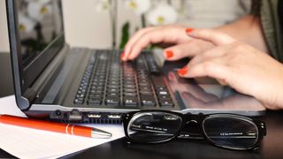 Woman typing on laptop