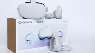 The Oculus Quest 2 headset sat on top of its box and next to its controllers