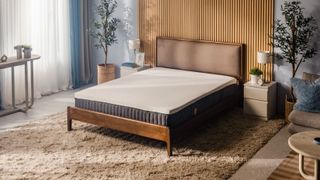 The Emma Luxe mattress on a bed frame in a neatly decorated modern room