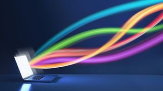 A concept image of internet speed with coloured ribbons flowing out of a computer