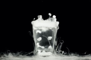 A glass of water visualized against a black background