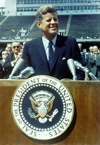 President Kennedy speaks before a crowd of 35,000 people at Rice University in the football field. 
