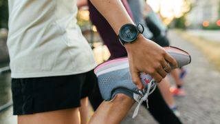 a photo of a woman holding her running shoe