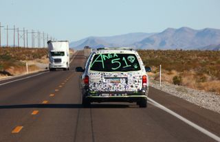 A car drives with "Area 51" written on the back before the start of a "Storm Area 51" spinoff event called "Area 51 Basecamp" on September 20, 2019 near Alamo, Nevada.