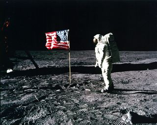 Apollo 11 astronaut Buzz Aldrin poses with the American flag on the surface of the moon in July 1969.