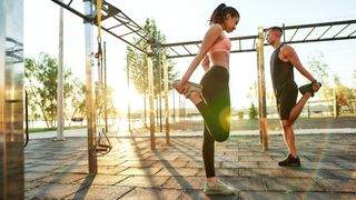 a man and a woman doing a quad stretch