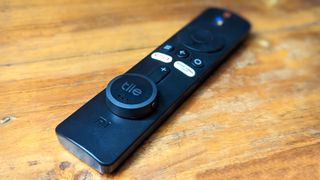 Tile Sticker Bluetooth tracker stuck on a Xiaomi Mi TV remote control.