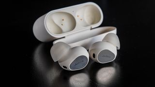 Jabra Elite 10 Gen 2 earbuds loose in front of open case.