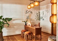 Lobby at the Alsace Hotel with a tiled mural and wooden desk