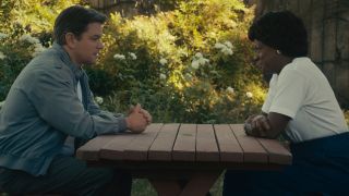 Matt Damon and Viola Davis sit at a picnic table in conversation in Air.