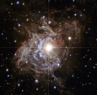 A Hubble Space Telescope image shows RS Puppis, one of the brightest Cepheids visible in our galaxy. Astrophysicists use stars like this to calculate the expansion rate of the universe.