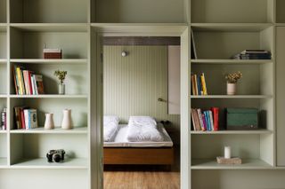 Pale green shelving in bedroon at Trevarefabrikken hotel Norway