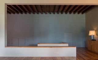 A staircase rises from the entrance foyer into an open-plan living and dining area