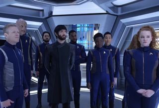 Stamets (Anthony Rapp), Saru (Doug Jones), Tyler (Shazad Latif), Spock (Ethan Peck), Bryce (Ronnie Rowe), Owosekun (Oyin Oladejo), Rhys (Patrick Kwok-Choon) and Tilly (Mary Wiseman) stand ready for their next journey in the "Star Trek: Discovery" episode "Such Sweet Sorrow.