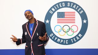 Snoop Dogg poses by the Team USA logo for the Paris 2024 Summer Olympics 