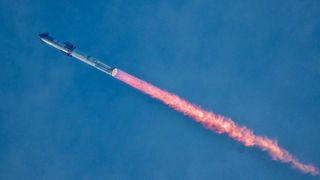 a large silver rocket streaks through the sky above a column of orange fire