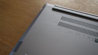 Bottom of the Asus ExpertBook P5 (P5405) on a wooden table showing the vents and the ExpertBook badging