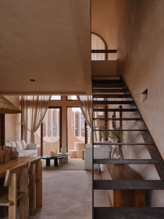 Living room area at a Babel Tulum holiday apartment, featuring soft hues and wooden fixtures