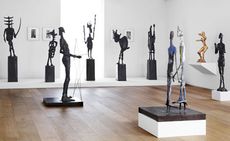 An exhibition space with eight bronze sculptures. 