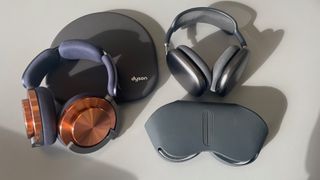 The Dyson OnTrac and Apple AirPods Max headphones lying on a surface with their respective cases.